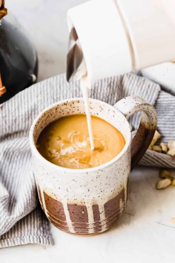 french vanilla creamer made with cashews being poured into coffee mug