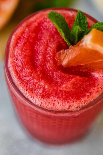 frozen watermelon paloma garnished with mint and a watermelon wedge